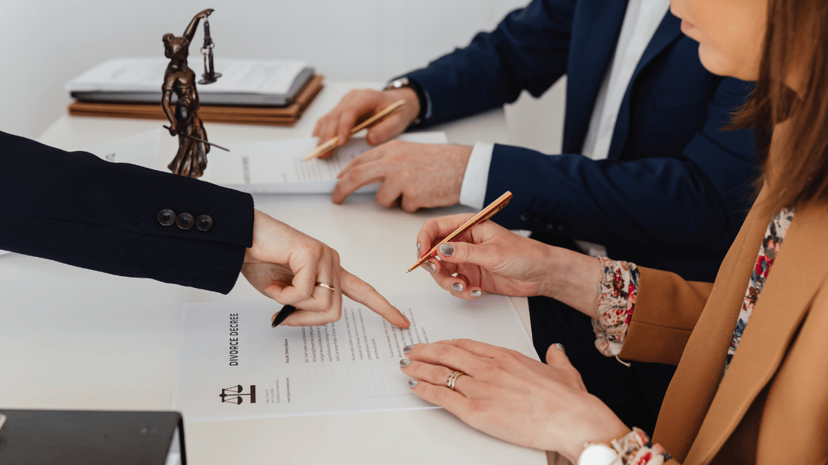 Person Signing on White Paper divorce papers